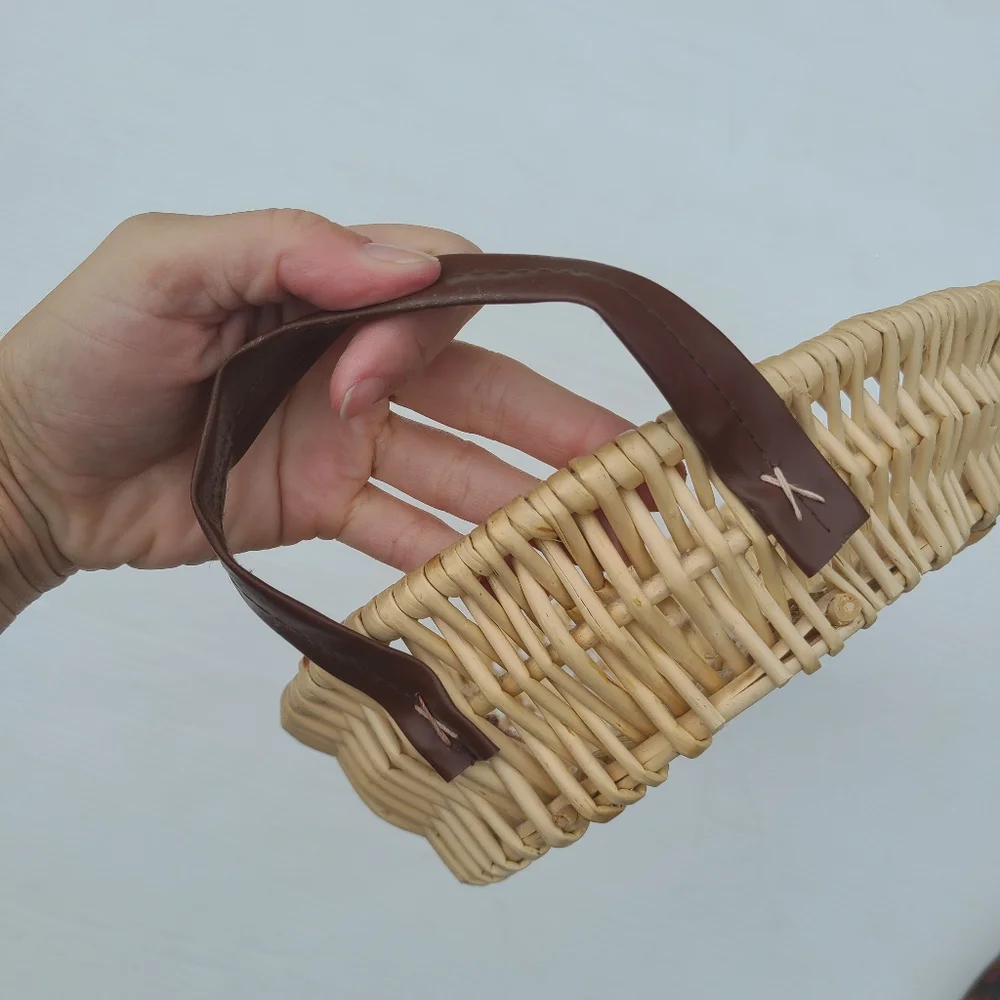 Woven wicker basket with faux leather handles